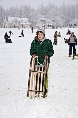 boy toboganning in Germany