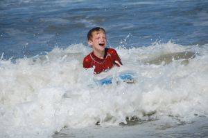 boy learning to surf