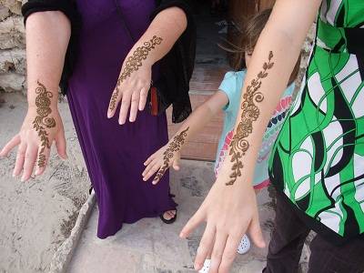mum and kids arms with henna on it